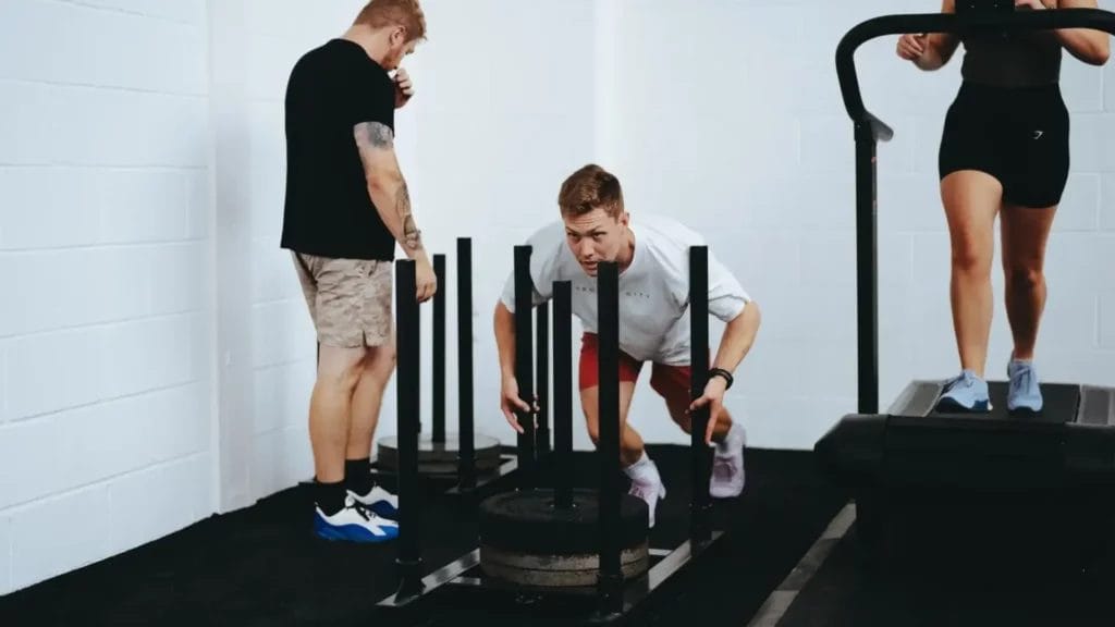 Man workout on sled machine